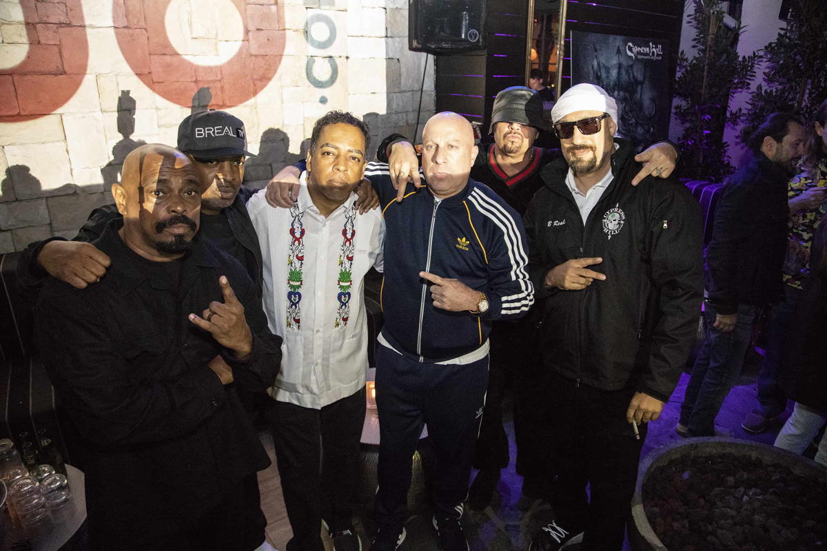 Chuck D from Public Enemy stands for a pic with Cypress Hill, as the 2018-era bud logo looms over their right shoulders, and the bud.com founders stand off to their left